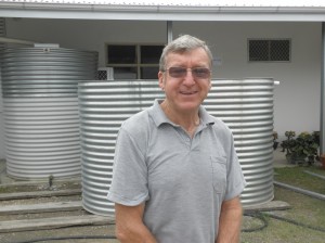 Norm Bruce with some of the rainwater tanks produced at the factory